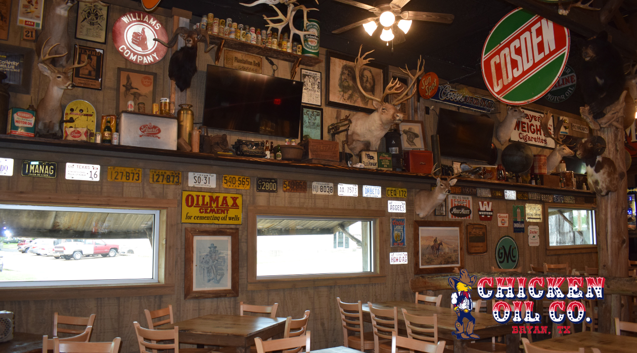 Interior of the Chicken Oil Co in Bryan, TX with the restaurant's logo in the bottom right corner.